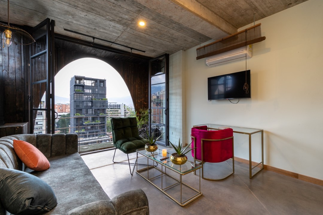 Spacious and well-lit living room in Hotel Medellin Nido Sky with designer furniture